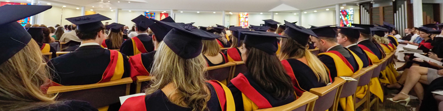 graduates sitting in chapel